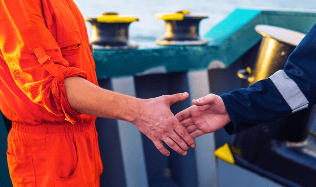 Two Seafarers shaking hands and about to make contact