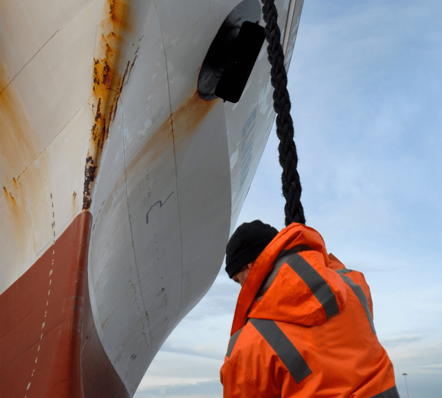 A crew member managing the vessel on a drydock