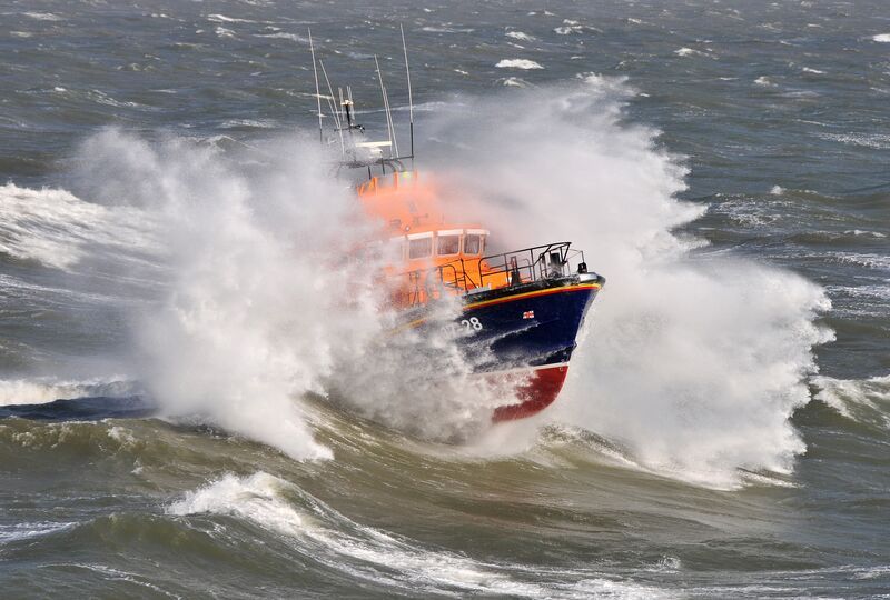 Lifeboat crashing through the waves on a lifesaving mission